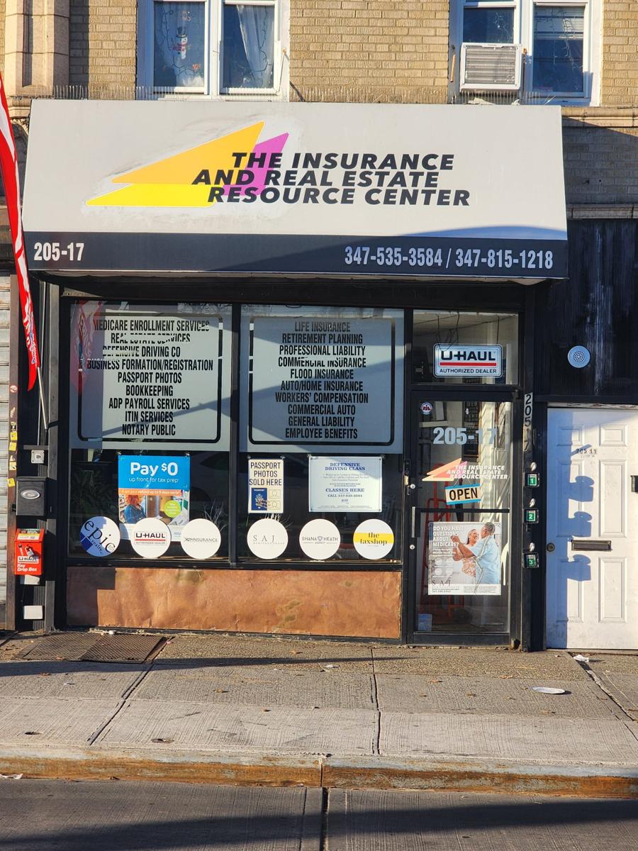 Storefront at 205-17 Jamaica Avenue in Hollis, Queens, with The Tax Shop sign in the window